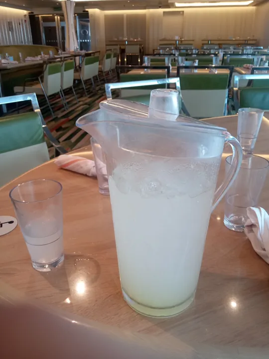 A pitcher and glass of lemonade